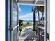 View from patio showcasing waterfront, palm trees, and seating at 1620 Casey Key Rd, Nokomis, FL 34275