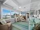 Sunroom features comfortable seating, a desk, and water views at 1620 Casey Key Rd, Nokomis, FL 34275