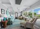 Relaxing sunroom with wicker seating and ocean views at 1620 Casey Key Rd, Nokomis, FL 34275