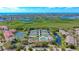 Community overview showcasing tennis courts, pool, and water features at 1620 Starling Dr # 204, Sarasota, FL 34231