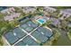 Aerial view showing tennis courts, pool, and buildings at 1620 Starling Dr # 204, Sarasota, FL 34231