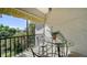 Screened balcony with table and chairs, offering a relaxing outdoor space at 1620 Starling Dr # 204, Sarasota, FL 34231