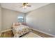 Bedroom with floral bedding and a pink accent table at 1620 Starling Dr # 204, Sarasota, FL 34231