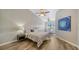 Bright bedroom with a striped bedspread and wood-look floors at 1620 Starling Dr # 204, Sarasota, FL 34231