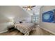 Bright bedroom with a striped bedspread and wood-look floors at 1620 Starling Dr # 204, Sarasota, FL 34231