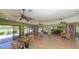 Bright community room with tables and bookshelves at 1620 Starling Dr # 204, Sarasota, FL 34231