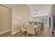 Dining area with glass-top table and four white chairs at 1620 Starling Dr # 204, Sarasota, FL 34231