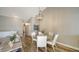 Round glass-top dining table with white chairs in open concept space at 1620 Starling Dr # 204, Sarasota, FL 34231