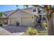Tan two-story home with two-car garage and landscaped front yard at 1620 Starling Dr # 204, Sarasota, FL 34231
