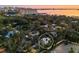Aerial view highlighting home in neighborhood with mature trees, parking, and city skyline backdrop at 1695 Lowe Dr, Sarasota, FL 34236