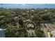 Aerial view of the property showcasing the building surrounded by vegetation and ocean in the distance at 1695 Lowe Dr, Sarasota, FL 34236