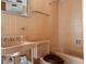 Retro bathroom with peach tile, bathtub, and vintage sink at 1695 Lowe Dr, Sarasota, FL 34236