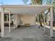 Covered carport with a door to the side, storage, and a bench at 1695 Lowe Dr, Sarasota, FL 34236