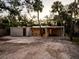 Mid-century modern home with carport and tropical landscaping at 1695 Lowe Dr, Sarasota, FL 34236