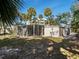 Home exterior view with screened porch and backyard at 1695 Lowe Dr, Sarasota, FL 34236