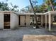 Contemporary home with a light exterior, thoughtfully landscaped with unique plantings and modern details at 1695 Lowe Dr, Sarasota, FL 34236