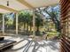 Bright sunroom with large windows, a terrazzo floor, and beautiful views of the lush yard at 1695 Lowe Dr, Sarasota, FL 34236