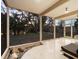 Bright sunroom with large windows, terrazzo floor, and serene view of backyard landscaping at 1695 Lowe Dr, Sarasota, FL 34236