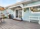 Back patio with gray composite deck, grill, and hanging planters at 1812 7Th W Ave, Bradenton, FL 34205