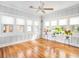 Bright sunroom with hardwood floors, multiple windows, and potted plants at 1812 7Th W Ave, Bradenton, FL 34205