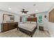 Spacious bedroom with king-size bed, wood dresser, and ceiling fan at 1819 Bridge St, Englewood, FL 34223