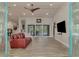 Open living space with vaulted ceiling, red couch and dining area at 1819 Bridge St, Englewood, FL 34223