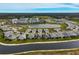 Aerial view of a luxury waterfront community with lake and villas at 192 Van Gogh Cv, Bradenton, FL 34212