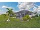 Spacious backyard with a screened patio and lush landscaping at 192 Van Gogh Cv, Bradenton, FL 34212