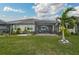 Backyard oasis featuring a screened patio and tropical landscaping at 192 Van Gogh Cv, Bradenton, FL 34212