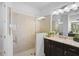 Bathroom with a large glass shower and dark vanity at 192 Van Gogh Cv, Bradenton, FL 34212