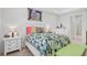 Bright bedroom with a tropical comforter and white nightstands at 192 Van Gogh Cv, Bradenton, FL 34212
