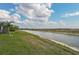 Peaceful waterfront view with lush landscaping and canal at 192 Van Gogh Cv, Bradenton, FL 34212