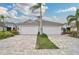 Two-car garage, paver driveway, and landscaped front yard at 192 Van Gogh Cv, Bradenton, FL 34212