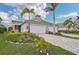 Two-car garage, paver driveway, and lush landscaping at 192 Van Gogh Cv, Bradenton, FL 34212