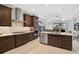 Spacious kitchen with island, stainless steel appliances, and dark wood cabinets at 192 Van Gogh Cv, Bradenton, FL 34212