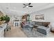 Spacious living room with L-shaped sectional sofa and a ceiling fan at 192 Van Gogh Cv, Bradenton, FL 34212