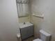 Small bathroom with updated vanity, toilet and mirror at 219 E Early St, Brooksville, FL 34601