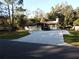Front view of a single story home with a large driveway at 219 E Early St, Brooksville, FL 34601