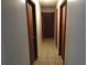 Long hallway with multiple doors leading to bedrooms and other rooms at 219 E Early St, Brooksville, FL 34601