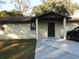 Front view of a single story home with a covered entry at 219 E Early St, Brooksville, FL 34601