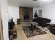 Living room with a stone fireplace and brown sofa at 219 E Early St, Brooksville, FL 34601