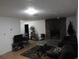 Living room with a stone fireplace and patterned rug at 219 E Early St, Brooksville, FL 34601