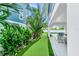 Landscaped backyard with putting green and lounge chair at 2208 Avenue A, Bradenton Beach, FL 34217