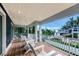 Spacious balcony with wooden flooring and white chairs at 2208 Avenue A, Bradenton Beach, FL 34217