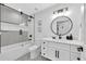 Modern bathroom with geometric tile and white vanity at 2208 Avenue A, Bradenton Beach, FL 34217
