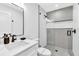 Modern bathroom with geometric tile and white vanity at 2208 Avenue A, Bradenton Beach, FL 34217