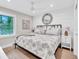 Guest bedroom with coastal decor, king-size bed, and TV at 2208 Avenue A, Bradenton Beach, FL 34217