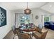 Bright dining room with round wooden table, wicker chairs, and water views at 2208 Avenue A, Bradenton Beach, FL 34217