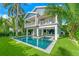Two-story home with a pool and lush landscaping at 2208 Avenue A, Bradenton Beach, FL 34217