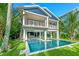 Two-story home with a large pool and a beautifully landscaped backyard at 2208 Avenue A, Bradenton Beach, FL 34217